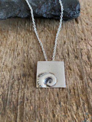 Curled octopus pendant